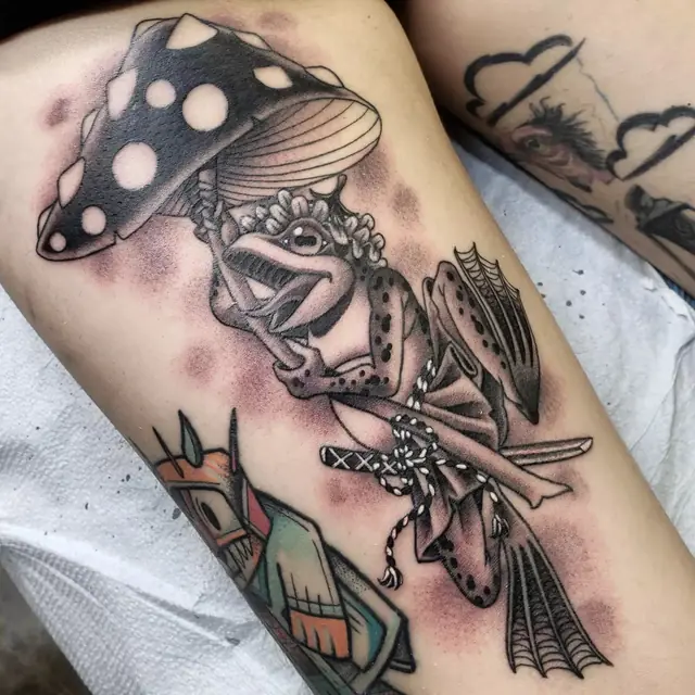 Frog with a samurai sword under a mushroom by Chris Carp at Heart & Sword Tattoo