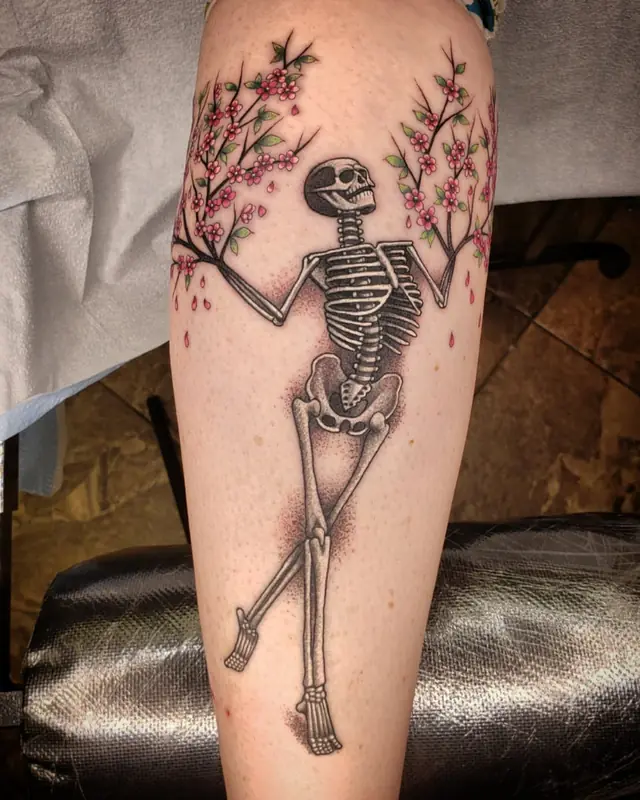 Dancing skeleton with cherry blossoms by Chris Carp at Heart & Sword Tattoo