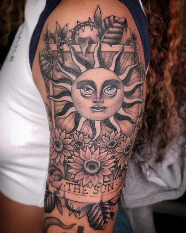 Black and gray 'The Sun' tarot and sunflowers by Chris Carp at Heart & Sword Tattoo