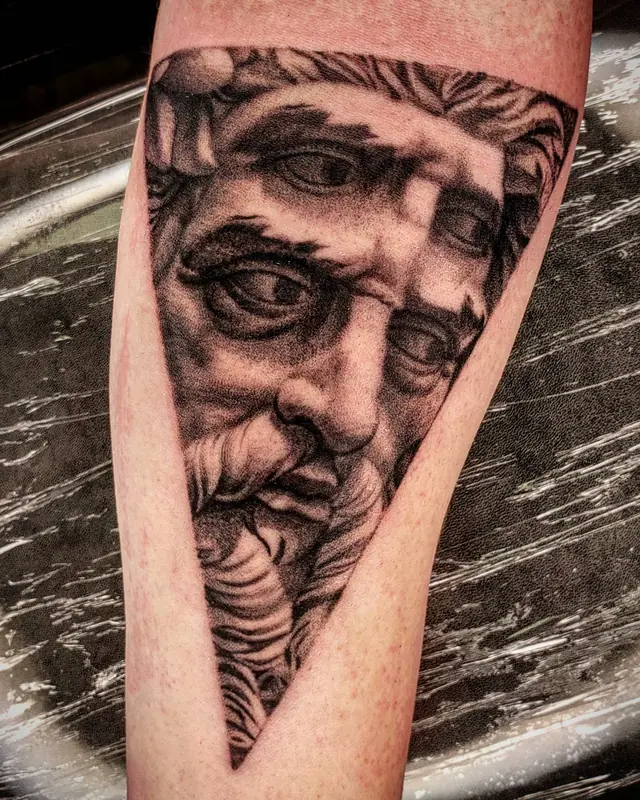 Stippled black and gray statue face tattoo by Chris Carp at Heart & Sword Tattoo