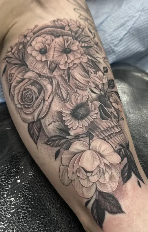 Black and gray skull and flowers by Johnny at Heart & Sword Tattoo